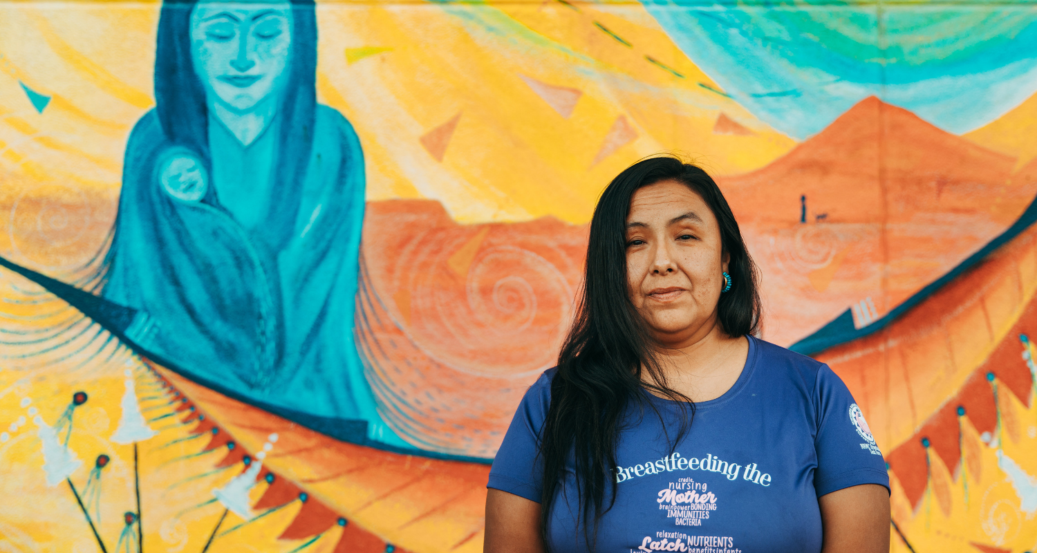 New Mexico mother stands in front of a mural