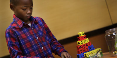 Young African American boy playing with blocks at Hope Starts Here announcement