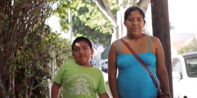 Noemi, a low-wage worker and participant of the UCLA Labor Center program, “Parent Worker Project,” is walking with her son in Los Angeles.