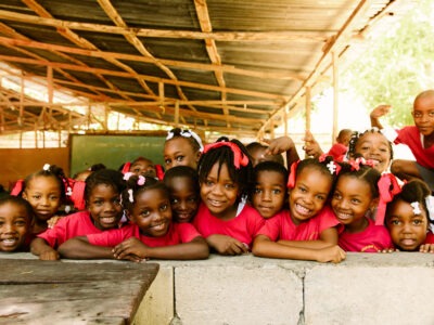 Building community - School children in Haiti dressed in red uniforms.