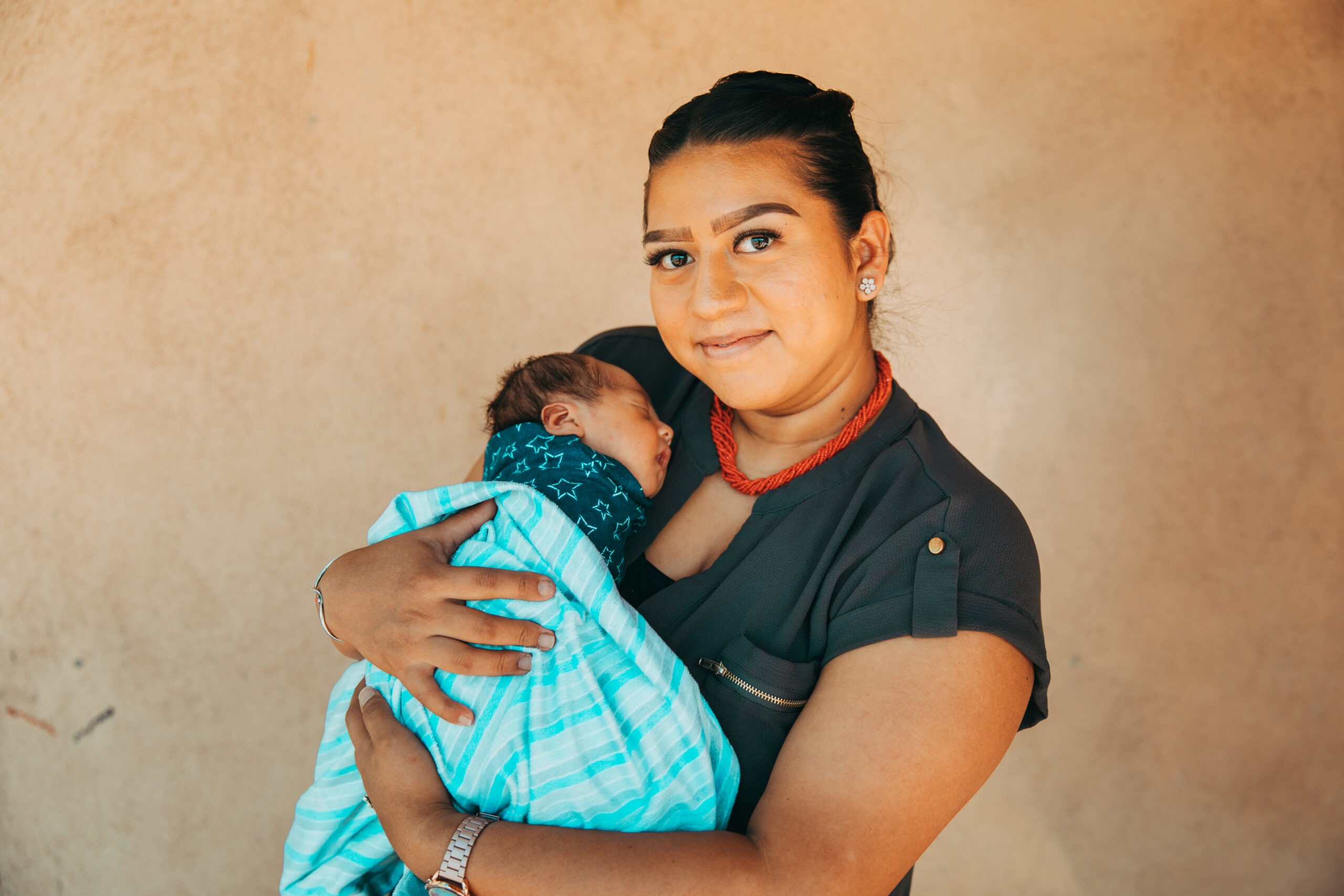 Mother holding her newborn infant.