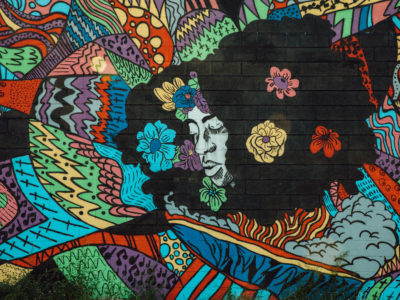 8 Mile's newest mural entitled "Detroit is a Black Woman." The mural features the head of a black woman surrounded by colorful graphics and flowers