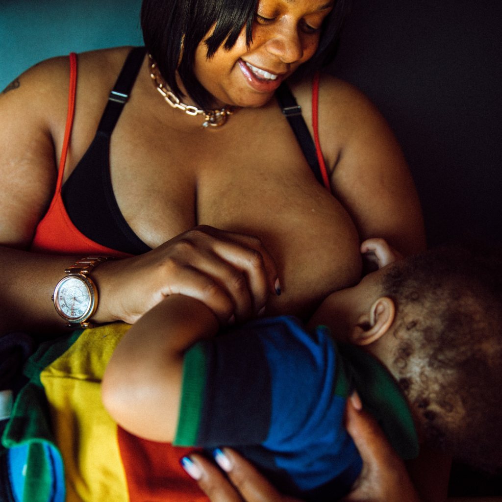 Robena Hill breastfeeds her son while sitting in a restaurant