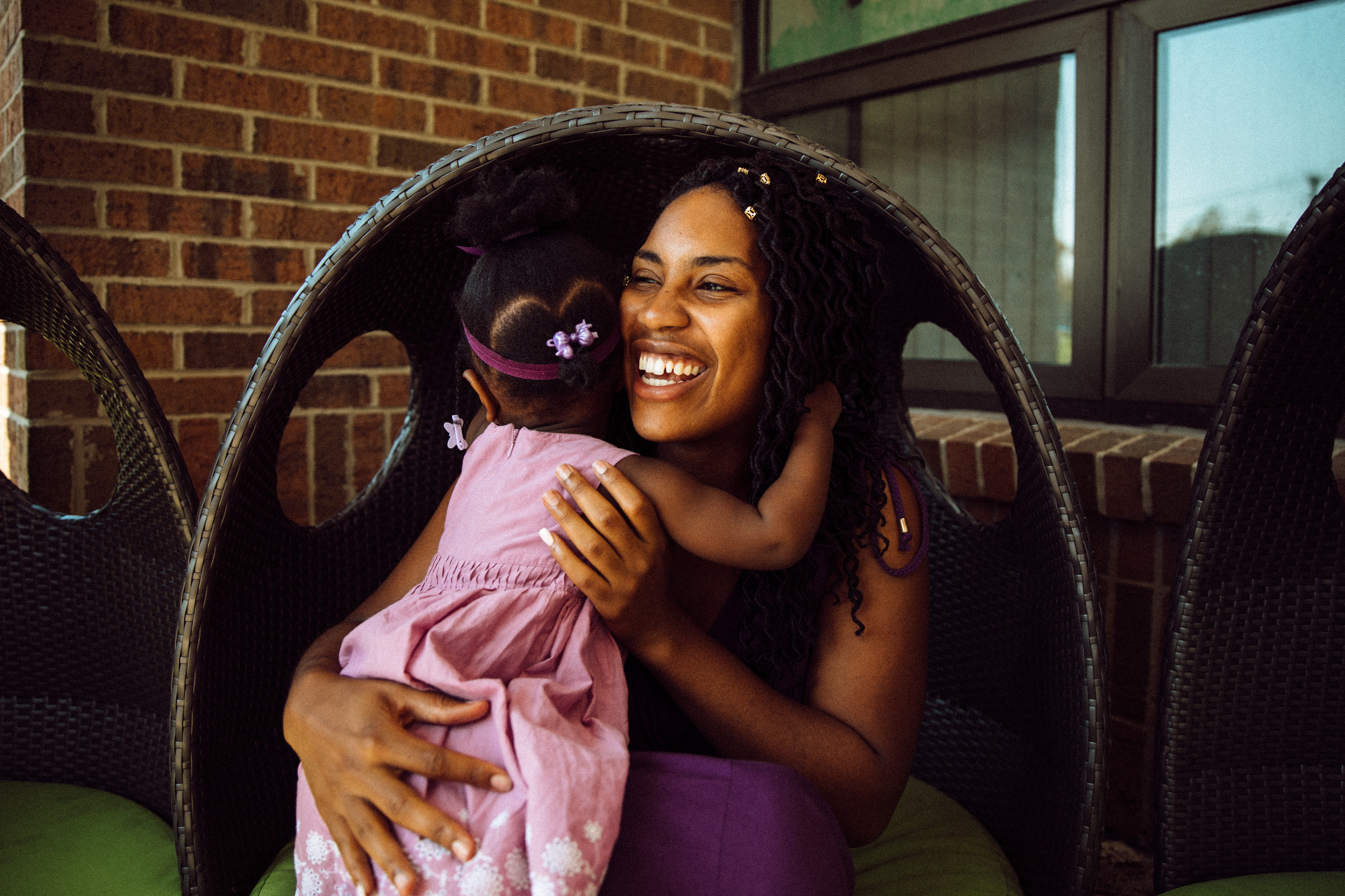 Victoria Washington smiles while giving her daughter a hug