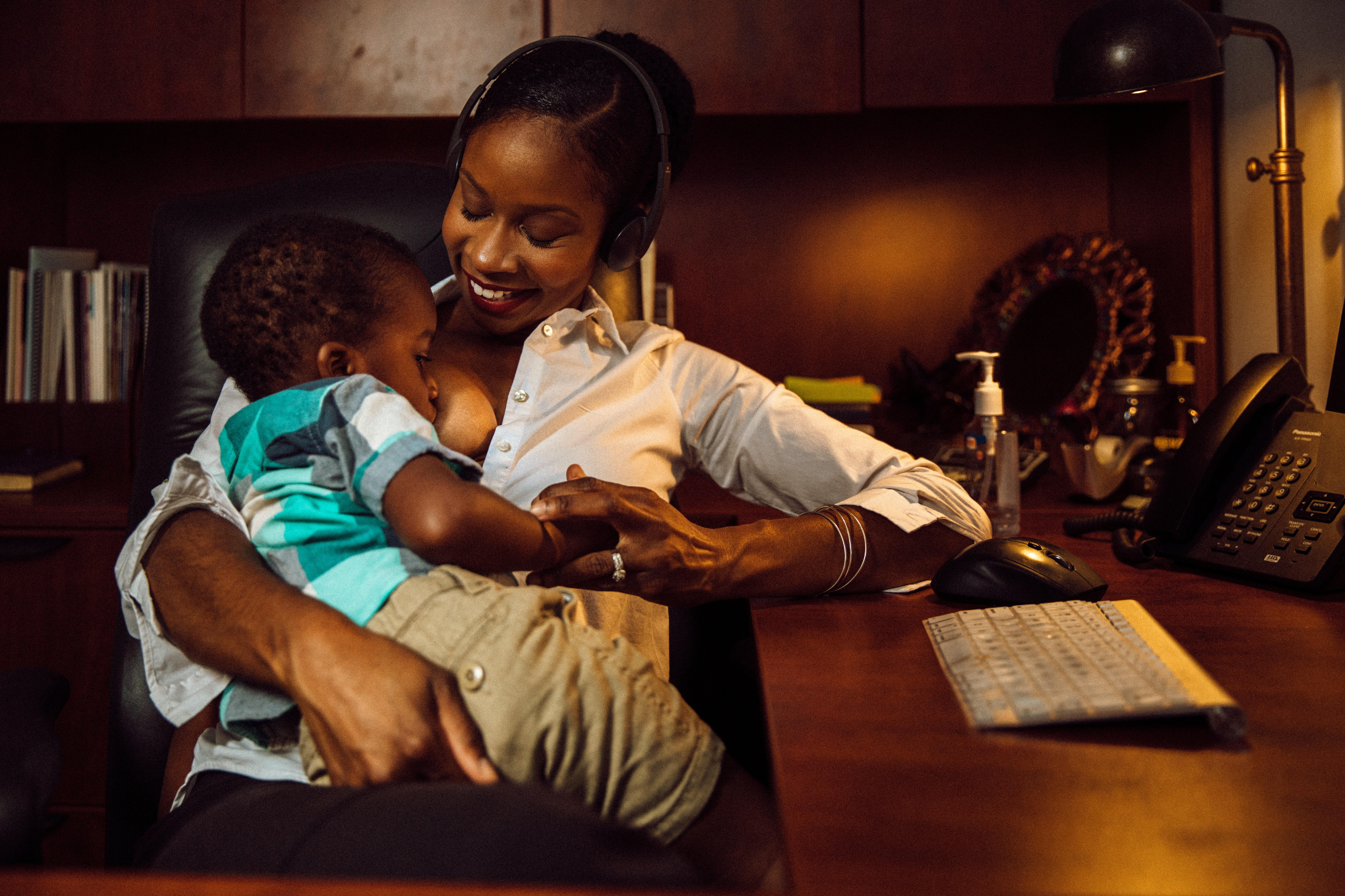 Malikah Garner breastfeeds her son in an office.