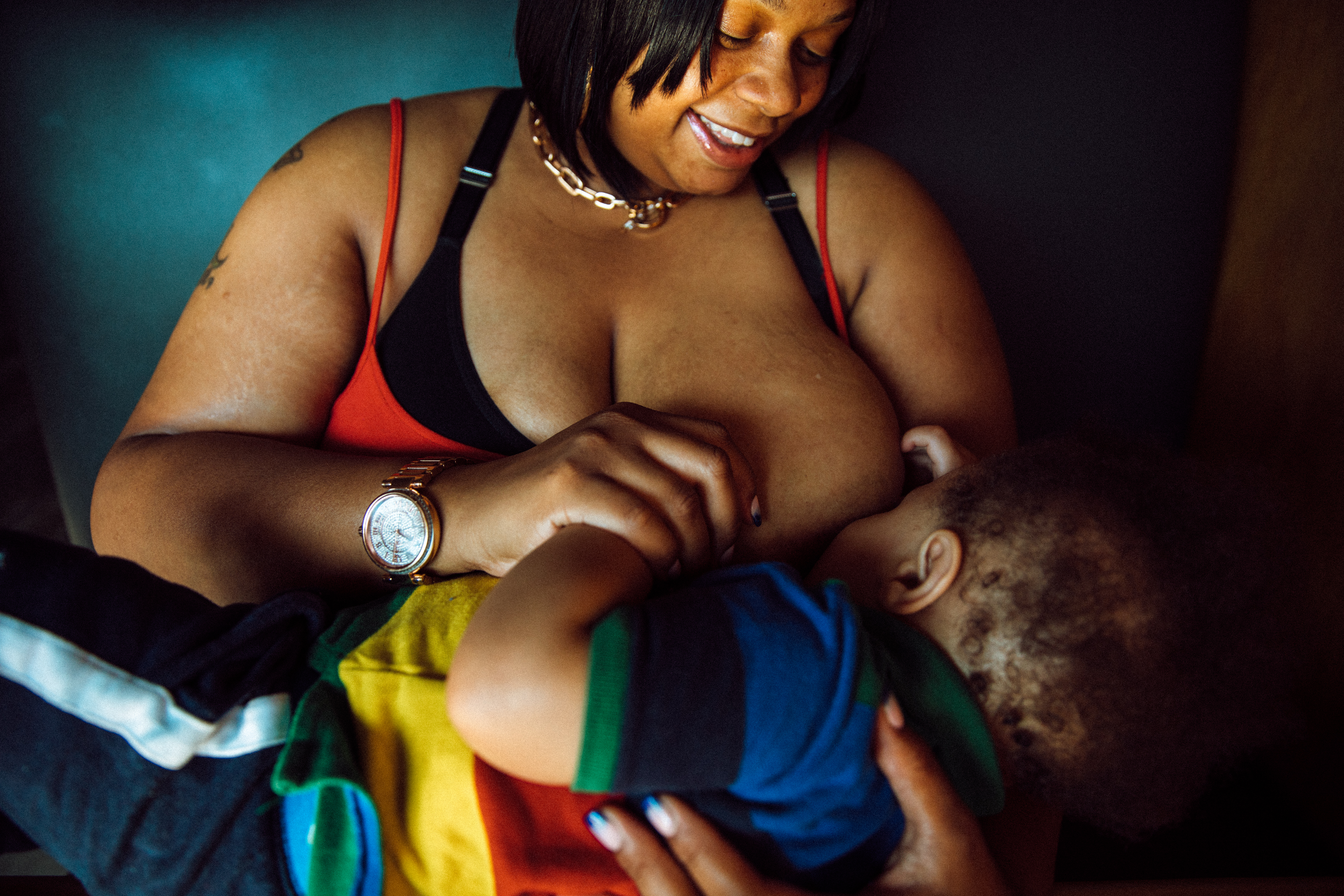 Robena Hill breastfeeds her son at a restaurant.