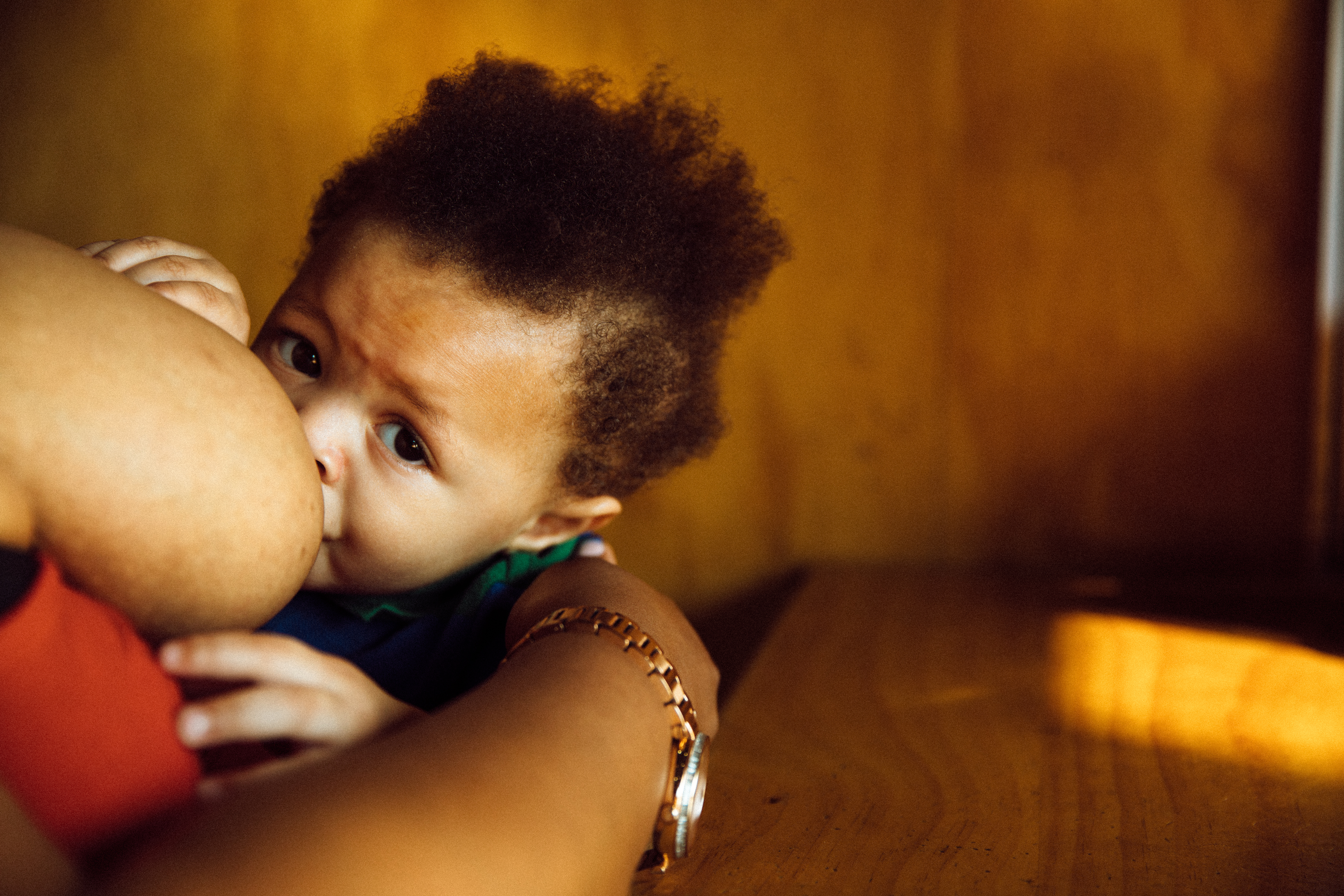 Robena Hill breastfeeds her son at a restaurant.