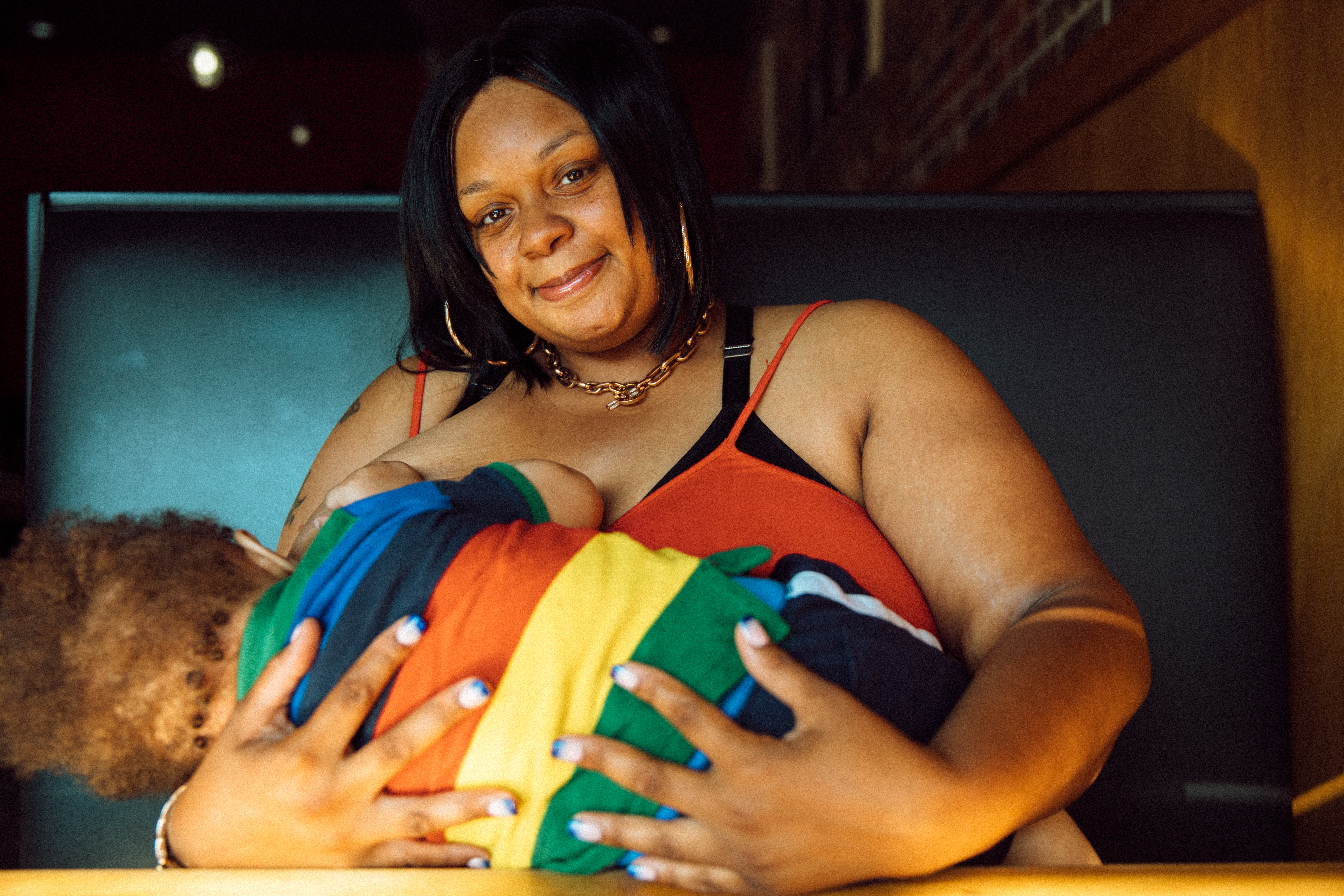 Robena Hill breastfeeds her son at a restaurant.