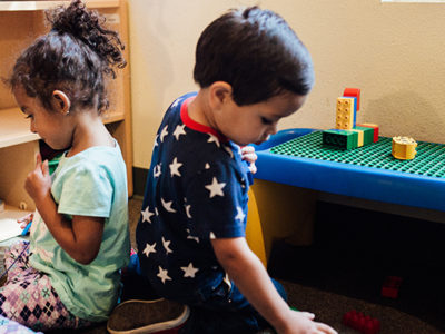 Equitable early learning - A young boy and a young girl play with toys in an early childhood education classroom