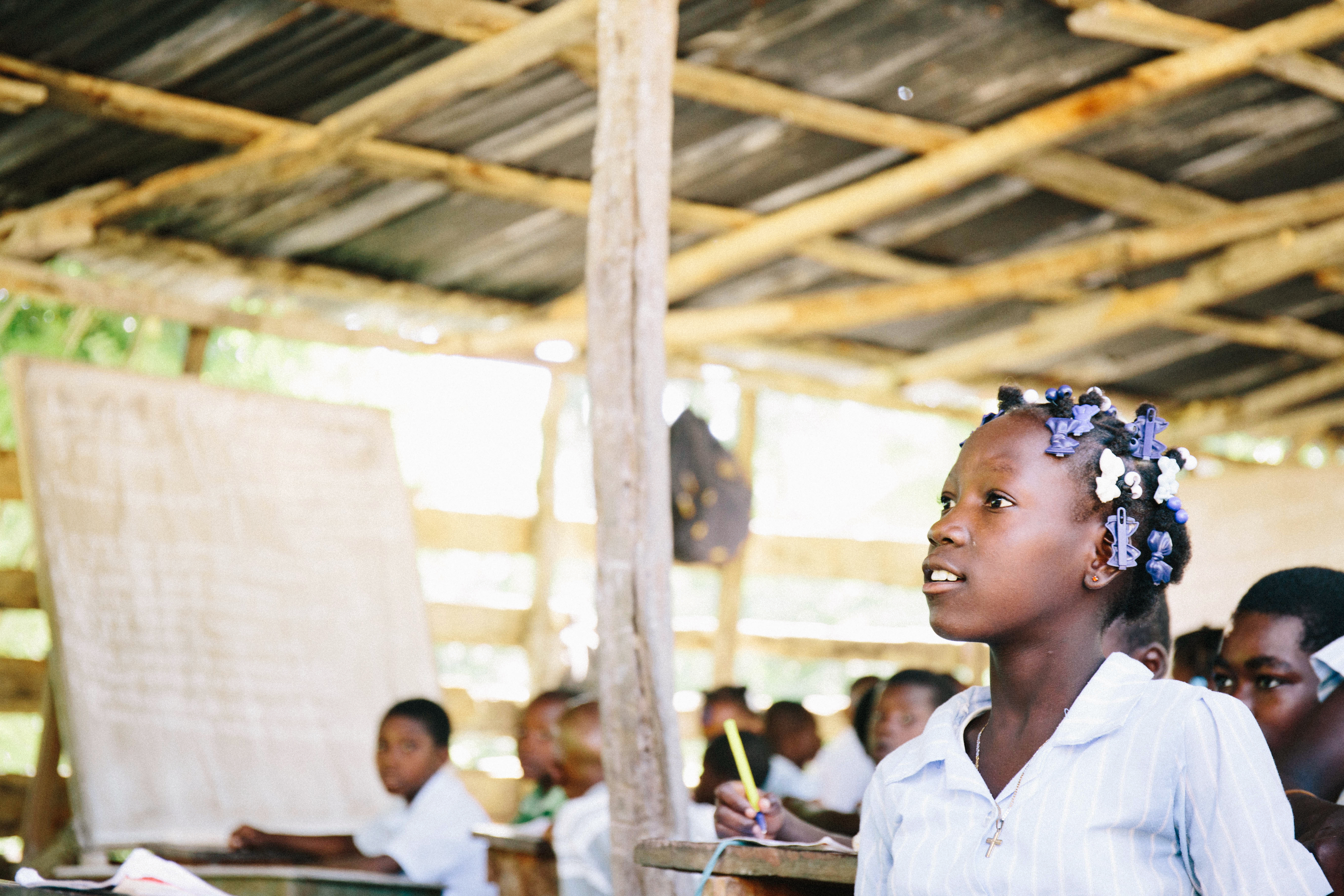 Educational Access - A student sitting in a classroom in Haiti.