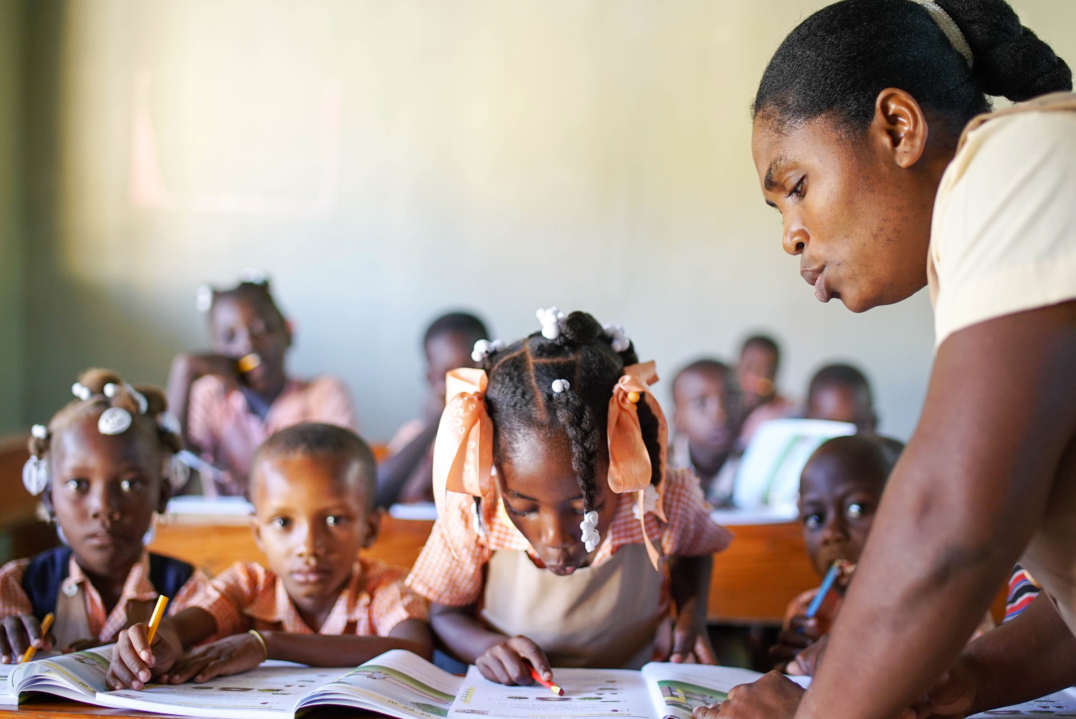 A student reading in a classroom in Haiti.