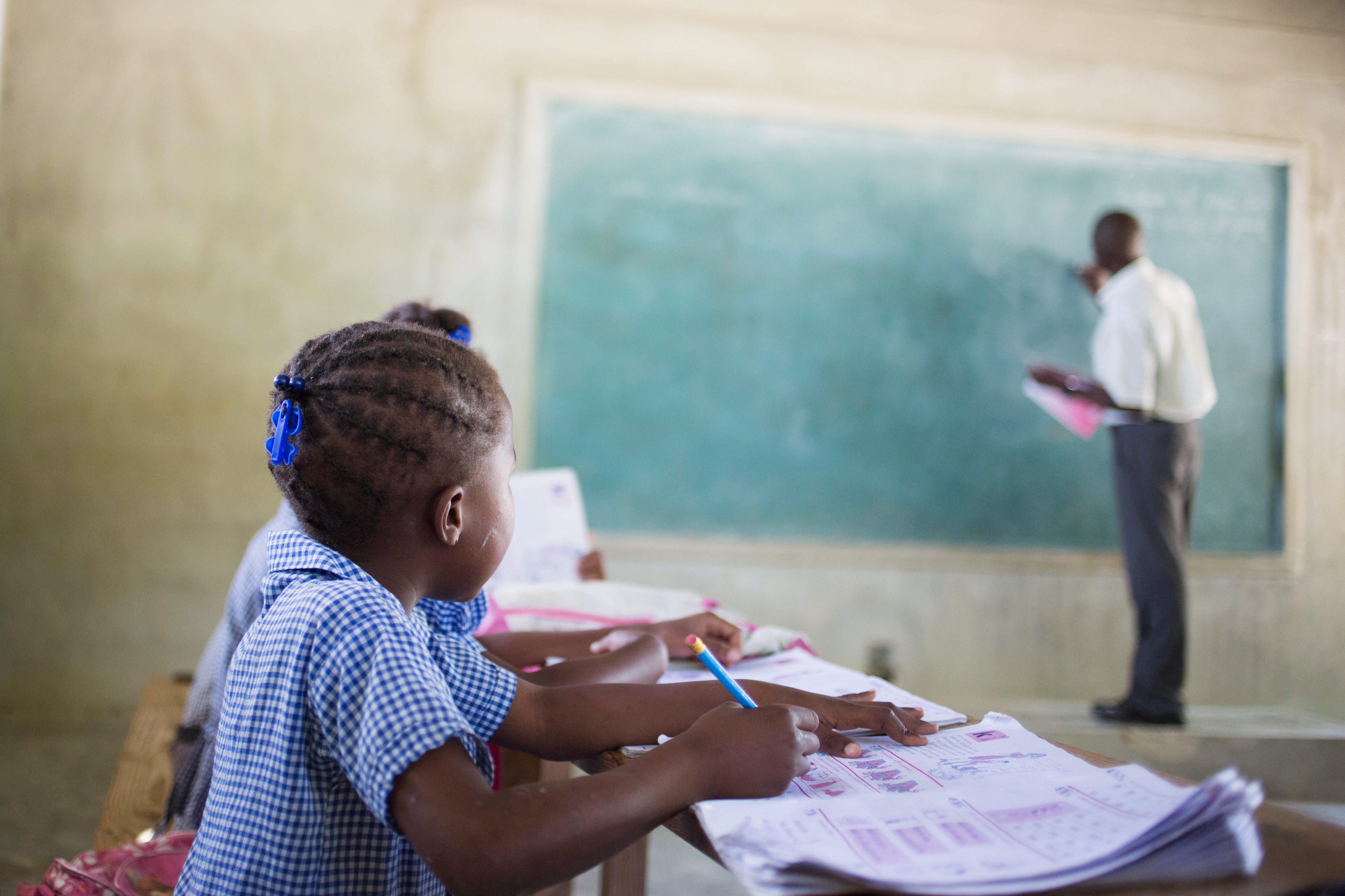 A student in Haiti looking at at the chalkboard.