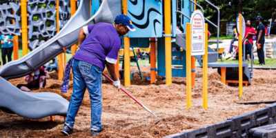 A volunteer helping put the sand in the new KaBOOM! playground in Drew, Mississippi.