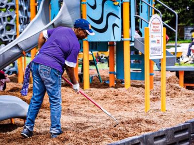 A volunteer helping put the sand in the new KaBOOM! playground in Drew, Mississippi. Playgrounds are important in early childhood development