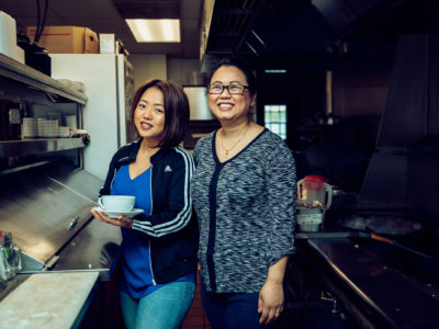 Amanda Sunthang and her mom, owners of Shwe Mandalay Burmese Cuisine restaurant located in Battle Creek, Michigan, standing in the kitchen.