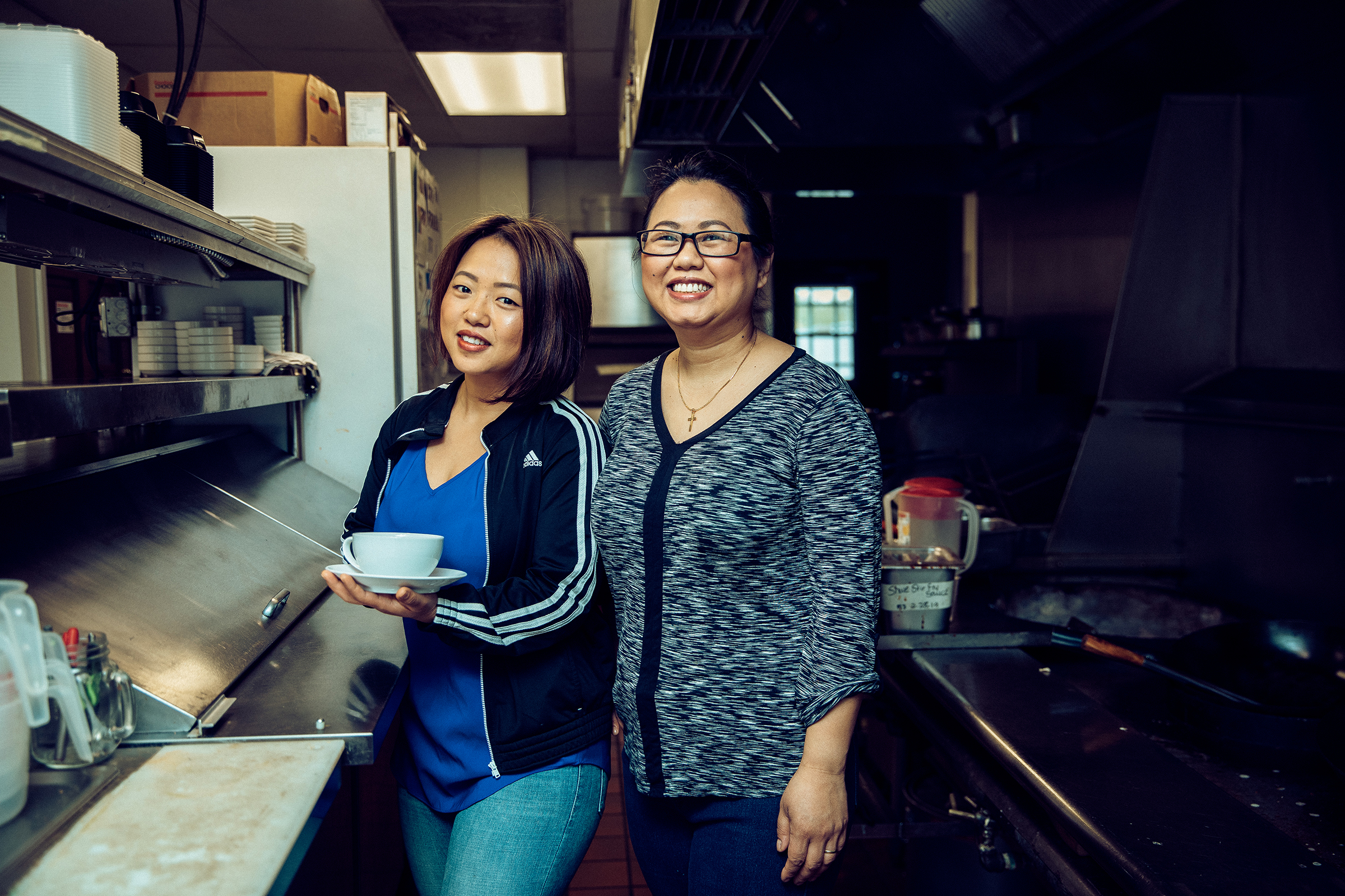 Amanda Sunthang and her mom, owners of Shwe Mandalay Burmese Cuisine restaurant located in Battle Creek, Michigan, standing in the kitchen.