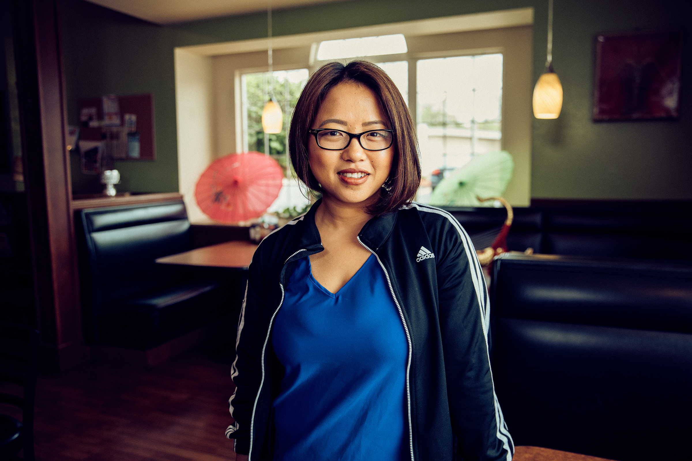 Amanda Sunthang, co-owner of Shwe Mandalay Burmese Cuisine restaurant, looking at the camera with a smile in Battle Creek, Michigan.