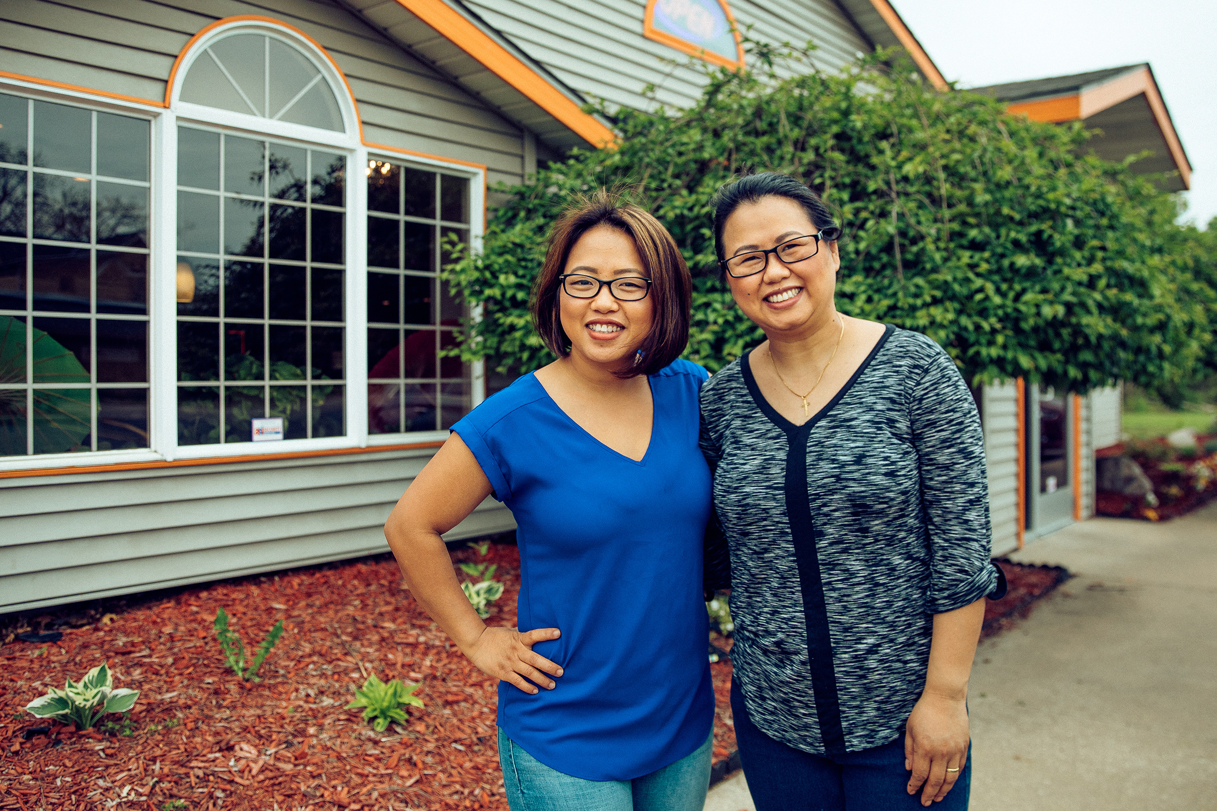 Amanda Sunthang and her sister, Jennifer, owners of Shwe Mandalay Burmese Cuisine, poses outside in front of the restaurant in Battle Creek, Michigan.