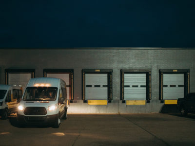 Aequitas van with its headlights on parked in a loading dock area in Battle Creek, MI. Aequitas removes transit barriers for employment opportunities.