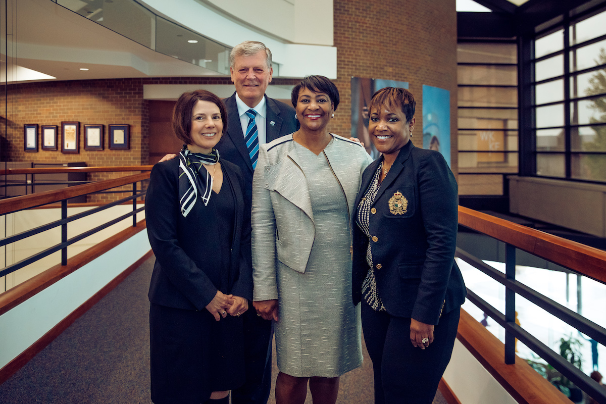 WKKF President and CEO La June Montgomery Tabron with three other people at the WKKF headquarters in Battle Creek, MI.