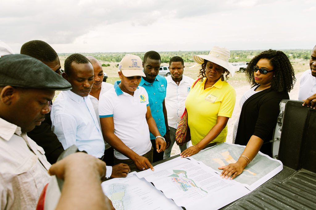 A group of Haitians discussing the the construction of new buildings in Haiti.