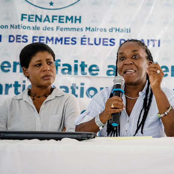 Josette Macillon and Marie-Ange Noel speaking on a panel at the 2019 Forum of Haitian Women Elected Officials.