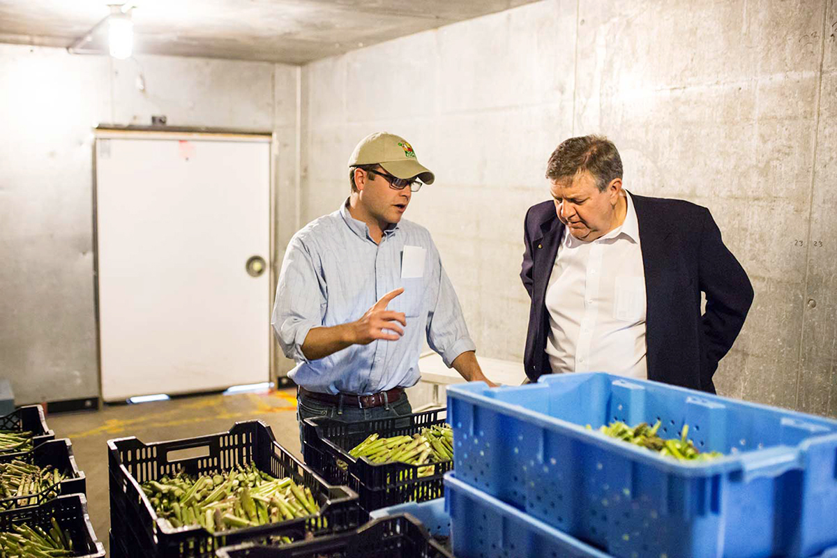 Brandon Seng, director of food programs for Goodwill Northern Michigan, explains the Farm to Freezer process to Representative Dan Benishek during a site visit. Photo: Farm to Freezer.