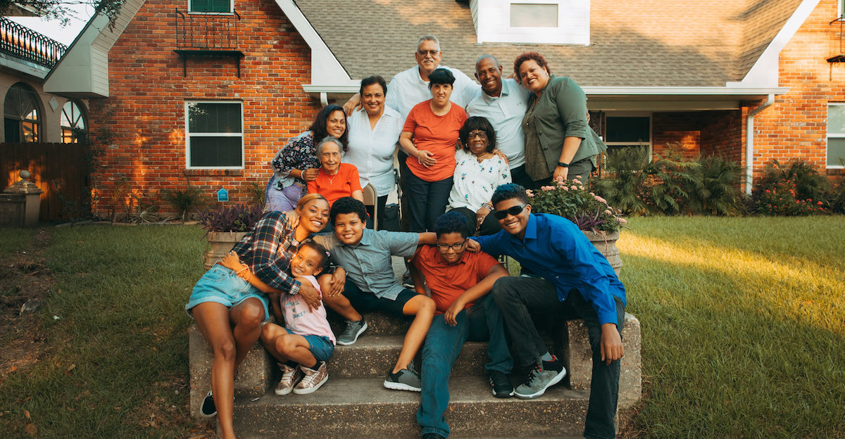 A family of 13 people on the front steps of their house in New Orleans.