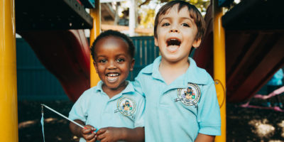 picture of two children - one black and one white - posing for a picture. Racial inequities is at the forefront of many conversations in New Orleans