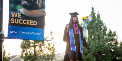 UCLA grad poses for picture after listening to commencement speech