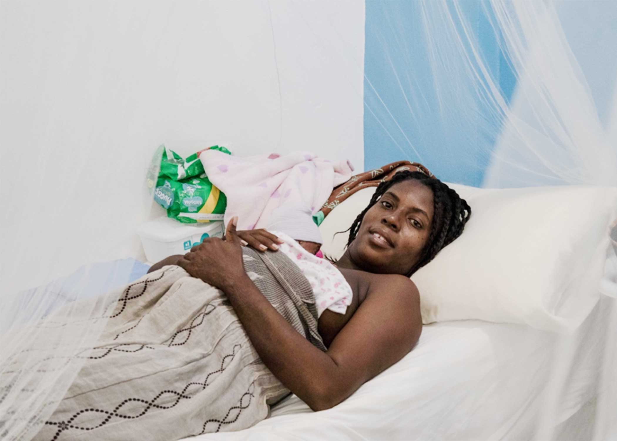 A Haitian mother practices the skin-to-skin technique with her baby in the comfort of a private room at the University Hospital in Haiti.