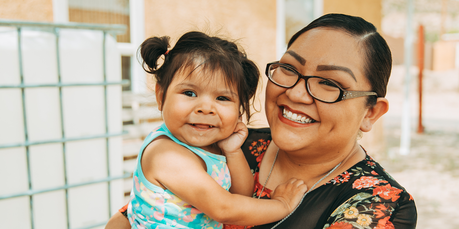 Photo of woman holding a toddler . Racial Equity 2030, a $90M global challenge