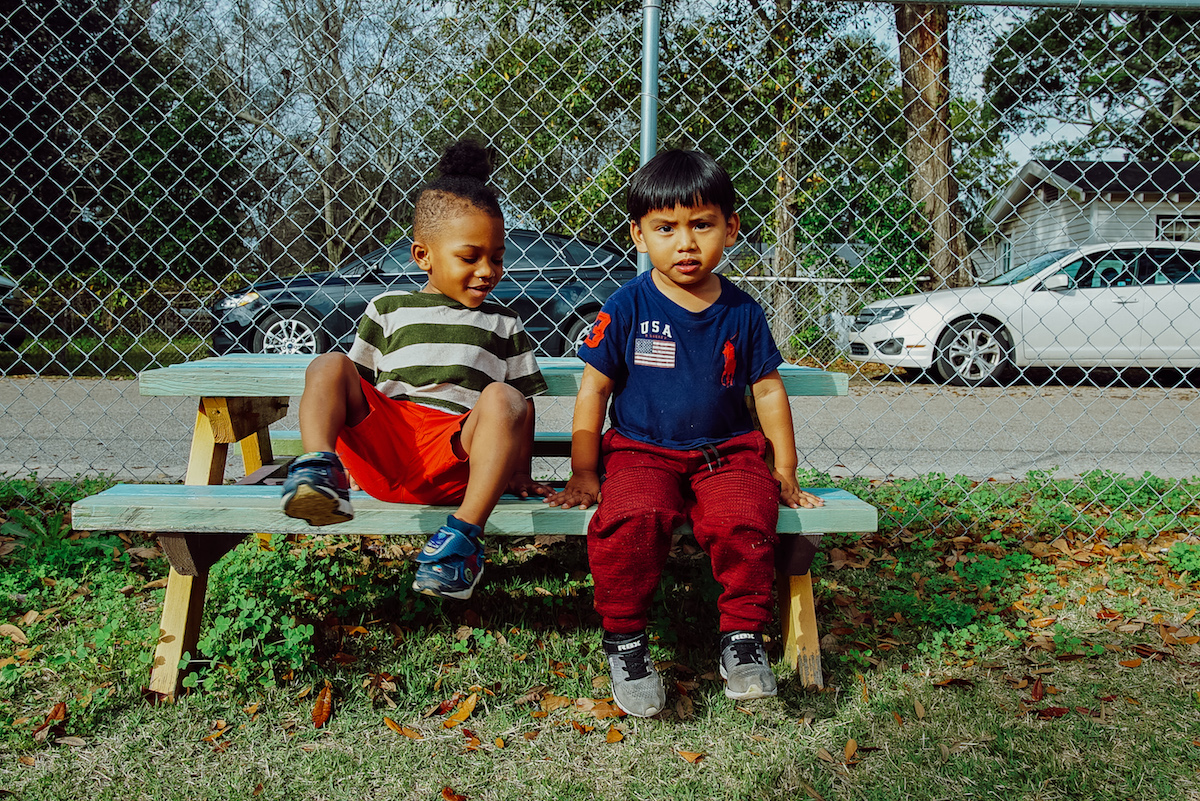 children sitting on park bench - medicaid expansion in Mississippi