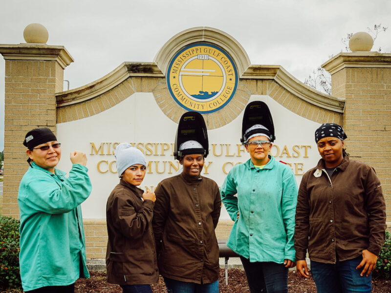 mississippi residents posing for a picture in front of the town sign. WKKF is establishing different methods for different communities