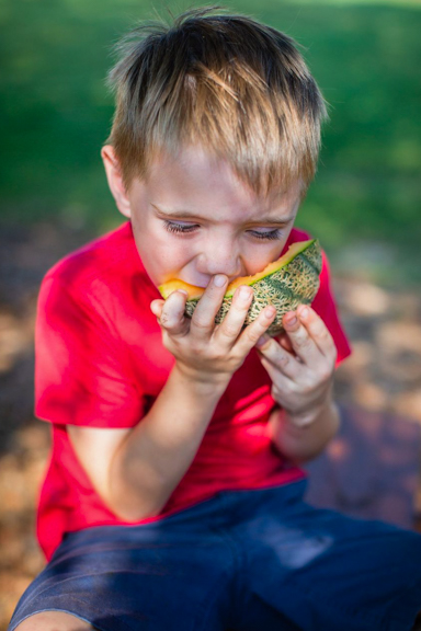 A child munches on a juicy cantaloupe grown from the child care center’s garden at The Learning Tree Academy in Toccoa, GA. Photo courtesy of Quality Care for Children.