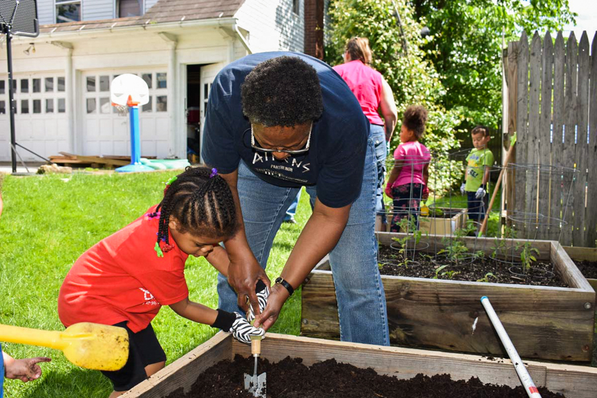 Ms. Cheryl Moss, with her young gardeners, preparing the soil at A Mother’s Touch Center for Child Development in Sharon, PA. Photo courtesy of The Food Trust.