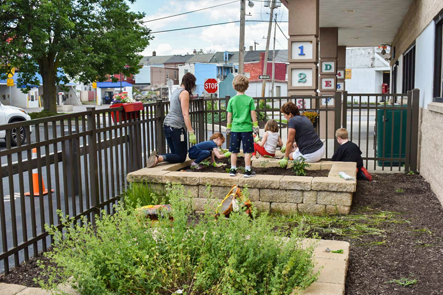 Early care and education providers and young children at work in the garden bed. Photo courtesy of Pennsylvania Farm to Early Care and Education Champion grantee.