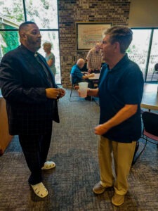 Bethel New Life Senior Pastor Rev. Dr. R. Keith Beauchamp speaks with a congregant during a Sunday morning fellowship gathering.