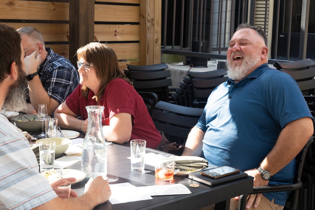 People chatting at a table | W.K. Kellogg Foundation