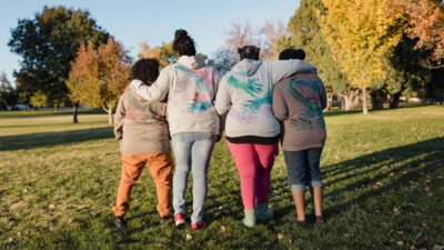 Black Leader's Circle Women in sweatshirts with hug prints on the back