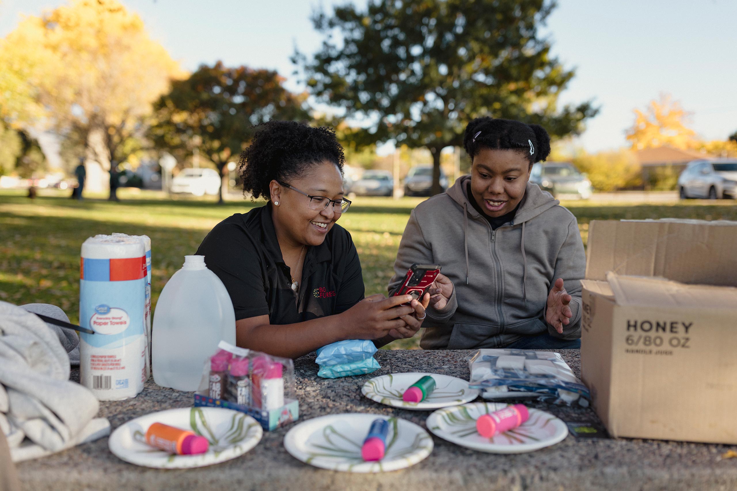 Heather Smith and Orchid Wilson prep paint for the group's "hug hoodies" project.