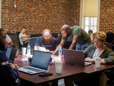 MCA students and instructors work through a coding problem together. Courtesy of Mississippi Coding Academies.