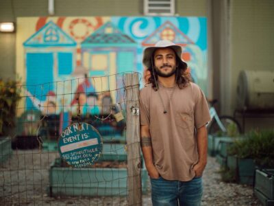 Alec Devaprasad stands at Sprout's community garden, where he went from tending his first garden bed to becoming an independent farmer.