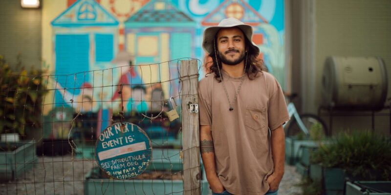 Alec Devaprasad stands at Sprout's community garden, where he went from tending his first garden bed to becoming an independent farmer.